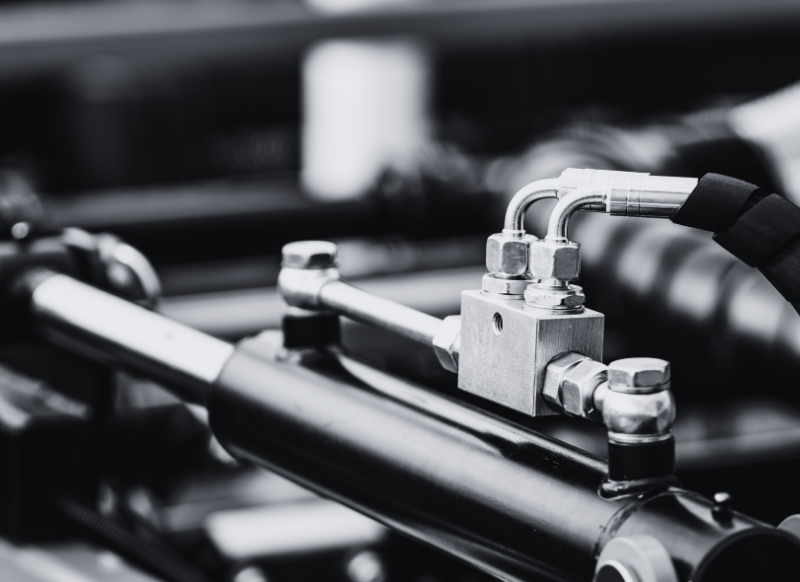 Hydraulic valve cutaway showing machined bore, spool lands, and sealing surfaces requiring tight tolerances